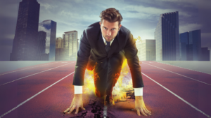 A sales manager poised for running a race, with flames around him, implying he is a winning sales manager.